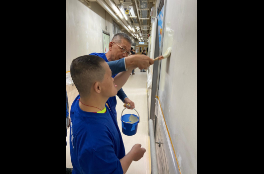 Volunteer and service user painted the wall together
