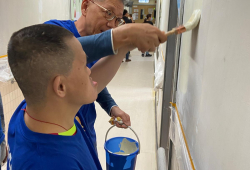 Volunteer and service user painted the wall together