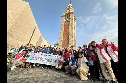 Volunteer and service users took group photo in front of Clock Tower